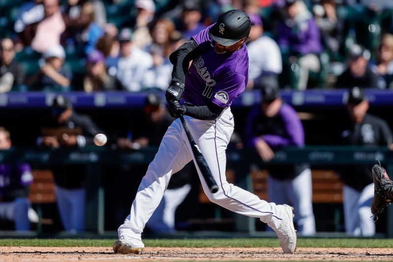 Apr 7, 2024; Denver, Colorado, USA; Colorado Rockies pinch hitter Jake Cave (11) hits a triple in the eighth inning against the Tampa Bay Rays at Coors Field. Mandatory Credit: Isaiah J. Downing-USA TODAY Sports