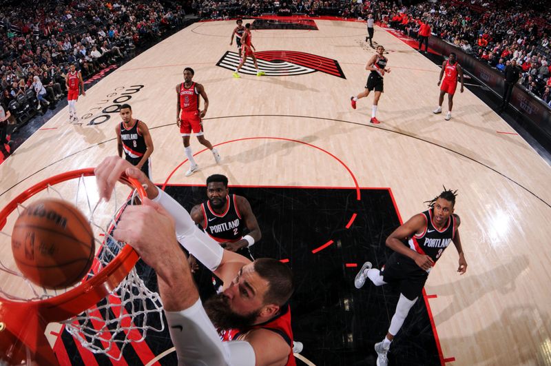 PORTLAND, OR - APRIL 9: Jonas Valanciunas #17 of the New Orleans Pelicans dunks the ball during the game against the Portland Trail Blazers on April 9, 2024 at the Moda Center Arena in Portland, Oregon. NOTE TO USER: User expressly acknowledges and agrees that, by downloading and or using this photograph, user is consenting to the terms and conditions of the Getty Images License Agreement. Mandatory Copyright Notice: Copyright 2024 NBAE (Photo by Cameron Browne/NBAE via Getty Images)