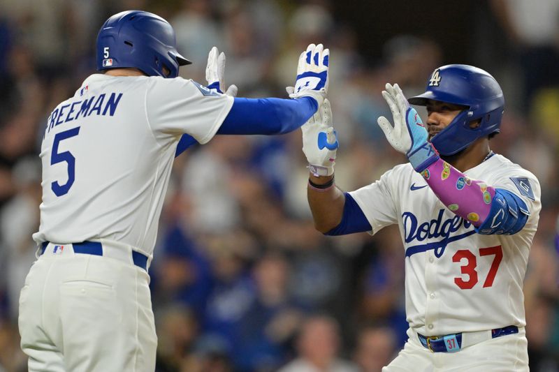 Sep 10, 2025; Los Angeles, California, USA; Los Angeles Dodgers right fielder Teoscar Hernandez (37) is greeted at the plate by first baseman Freddie Freeman (5) after hitting solo home run during the eighth inning against the Colorado Rockies at Dodger Stadium. Mandatory Credit: Jayne Kamin-Oncea-Imagn Images
