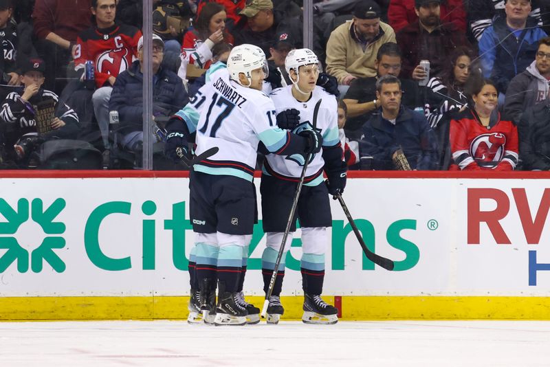 Dec 6, 2024; Newark, New Jersey, USA; Seattle Kraken center Shane Wright (51) celebrates his goal against the New Jersey Devils during the second period at Prudential Center. Mandatory Credit: Ed Mulholland-Imagn Images