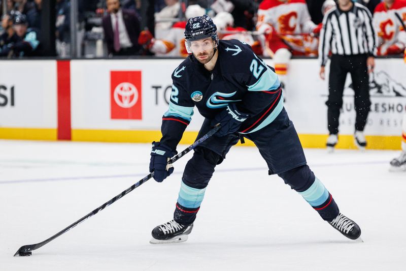 Oct 19, 2024; Seattle, Washington, USA; Seattle Kraken right wing Oliver Bjorkstrand (22) shoots against the Calgary Flames during the first period at Climate Pledge Arena. Mandatory Credit: Caean Couto-Imagn Images