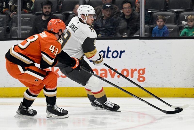 Dec 4, 2024; Anaheim, California, USA;  Vegas Golden Knights center Jack Eichel (9) handles the puck against Anaheim Ducks defenseman Drew Helleson (43) during the first period at Honda Center. Mandatory Credit: Alex Gallardo-Imagn Images