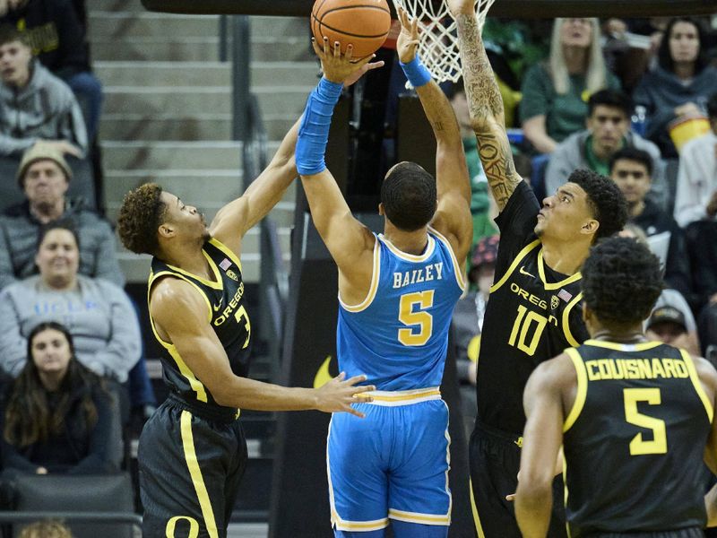 Feb 11, 2023; Eugene, Oregon, USA; UCLA Bruins guard Amari Bailey (5) drives to the basket against Oregon Ducks guard Keeshawn Barthelemy (3) and center Kel'el Ware (10) during the first half at Matthew Knight Arena. Mandatory Credit: Troy Wayrynen-USA TODAY Sports