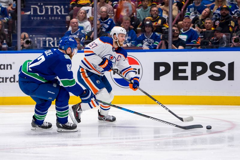 May 10, 2024; Vancouver, British Columbia, CAN; Edmonton Oilers forward Connor McDavid (97) shoots around Vancouver Canucks defenseman Ian Cole (82) during the second period in game two of the second round of the 2024 Stanley Cup Playoffs at Rogers Arena. Mandatory Credit: Bob Frid-USA TODAY Sports