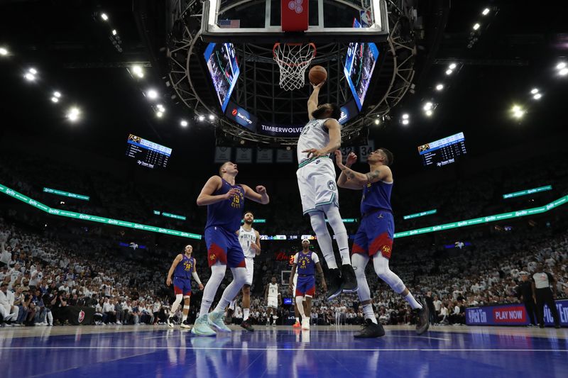 MINNEAPOLIS, MN -  MAY 16: Karl-Anthony Towns #32 of the Minnesota Timberwolves grabs the rebound during the game against the Denver Nuggets during Round 2 Game 6 of the 2024 NBA Playoffs on May 16, 2024 at Target Center in Minneapolis, Minnesota. NOTE TO USER: User expressly acknowledges and agrees that, by downloading and or using this Photograph, user is consenting to the terms and conditions of the Getty Images License Agreement. Mandatory Copyright Notice: Copyright 2024 NBAE (Photo by Jordan Johnson/NBAE via Getty Images)