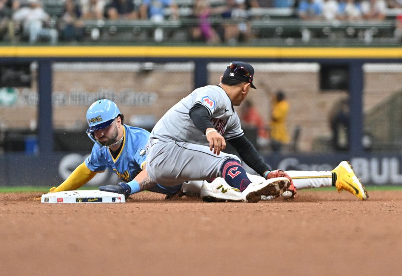 Aug 16, 2024; Milwaukee, Wisconsin, USA; Milwaukee Brewers outfielder Garrett Mitchell (5) slides in safely ahead of the tag by Cleveland Guardians second base Andrés Giménez (0) in the eighth inning at American Family Field. Mandatory Credit: Michael McLoone-USA TODAY Sports