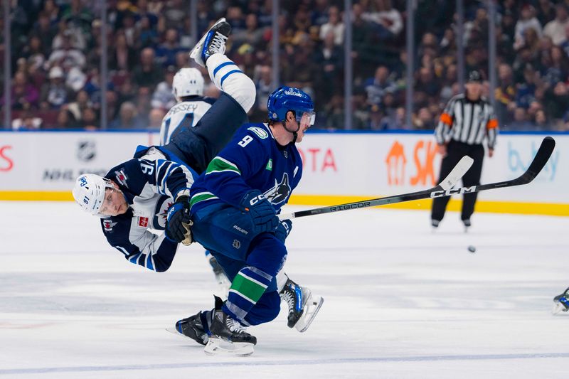 Feb 17, 2024; Vancouver, British Columbia, CAN; Winnipeg Jets forward Cole Perfetti (91) collides with Vancouver Canucks forward J.T. Miller (9) in the third period at Rogers Arena. Jets won 4-2. Mandatory Credit: Bob Frid-USA TODAY Sports