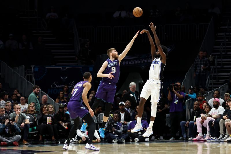 CHARLOTTE, NORTH CAROLINA - MARCH 05: Davis Bertans #9 of the Charlotte Hornets defends a shot by Jonathan Isaac #1 of the Orlando Magic during the first half of an NBA game at Spectrum Center on March 05, 2024 in Charlotte, North Carolina. NOTE TO USER: User expressly acknowledges and agrees that, by downloading and or using this photograph, User is consenting to the terms and conditions of the Getty Images License Agreement. (Photo by David Jensen/Getty Images)