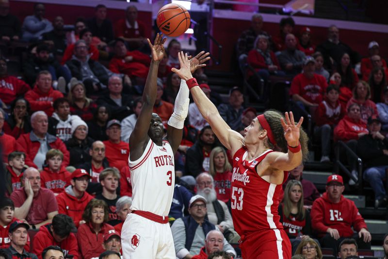 Jan 17, 2024; Piscataway, New Jersey, USA; Rutgers Scarlet Knights forward Mawot Mag (3) shoots the ball as Nebraska Cornhuskers forward Josiah Allick (53) defends  during the second half at Jersey Mike's Arena. Mandatory Credit: Vincent Carchietta-USA TODAY Sports