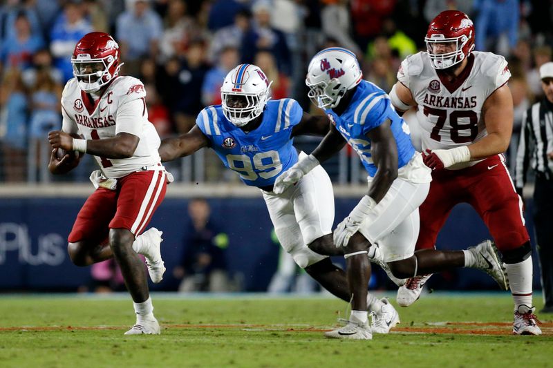 Oct 7, 2023; Oxford, Mississippi, USA; Arkansas Razorbacks quarterback KJ Jefferson (1) runs the ball as Mississippi Rebels defensive linemen Isaac Ukwu (99) pursues during the second half at Vaught-Hemingway Stadium. Mandatory Credit: Petre Thomas-USA TODAY Sports