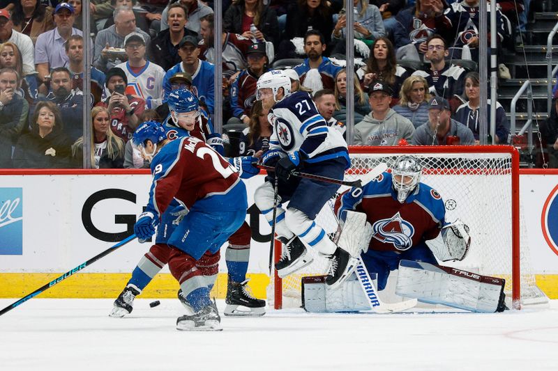 Apr 26, 2024; Denver, Colorado, USA; The puck defects off of Colorado Avalanche center Nathan MacKinnon (29) as Winnipeg Jets left wing Nikolaj Ehlers (27) and defenseman Cale Makar (8) battle for position in front of goaltender Alexandar Georgiev (40) in the second period in game three of the first round of the 2024 Stanley Cup Playoffs at Ball Arena. Mandatory Credit: Isaiah J. Downing-USA TODAY Sports