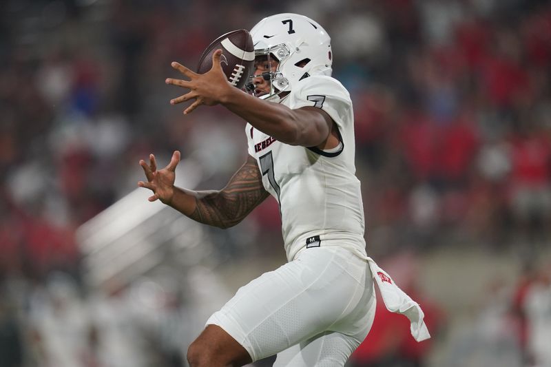 Sep 24, 2021; Fresno, California, USA; UNLV Rebels quarterback Cameron Friel (7) momentarily loses control of the ball against the Fresno State Bulldogs in the fourth quarter at Bulldog Stadium. Mandatory Credit: Cary Edmondson-USA TODAY Sports