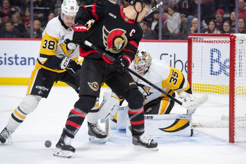 Dec 14, 2024; Ottawa, Ontario, CAN; Pittsburgh Penguins goalie Tristan Jarry (35) makes a save in front of Ottawa Senators left wing Brady Tkachuk (7) in the first period against at the Canadian Tire Centre. Mandatory Credit: Marc DesRosiers-Imagn Images