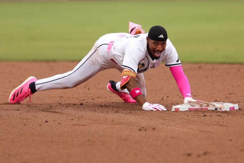 May 11, 2025; Tampa, Florida, USA; Tampa Bay Rays left fielder Chandler Simpson (14) slides into second base after hitting a double against the Milwaukee Brewers in the fifth inning at George M. Steinbrenner Field. Mandatory Credit: Nathan Ray Seebeck-Imagn Images