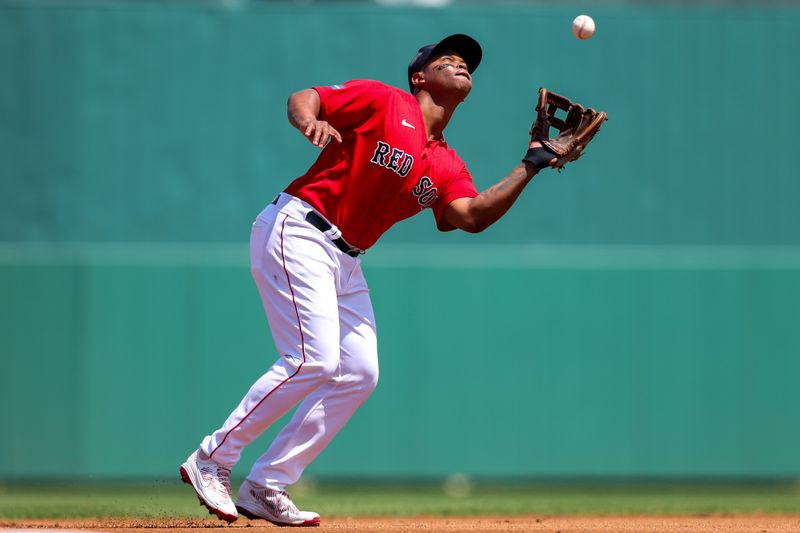 Mar 28, 2023; Fort Myers, Florida, USA;  Boston Red Sox third baseman Rafael Devers (11) fields a fly ball against the Boston Red Sox in the first inning during spring training at JetBlue Park at Fenway South. Mandatory Credit: Nathan Ray Seebeck-USA TODAY Sports