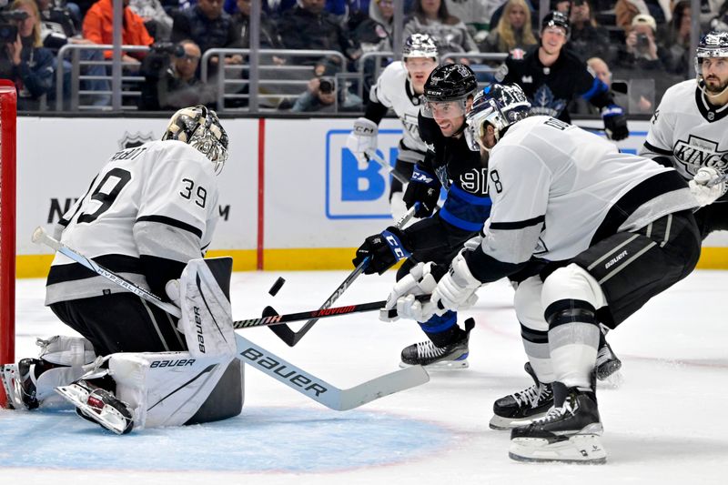 Jan 2, 2024; Los Angeles, California, USA; Los Angeles Kings goaltender Cam Talbot (39) makes a save off a shot by Toronto Maple Leafs center John Tavares (91) as Los Angeles Kings defenseman Drew Doughty (8) defends during the third period at Crypto.com Arena. Mandatory Credit: Jayne Kamin-Oncea-USA TODAY Sports