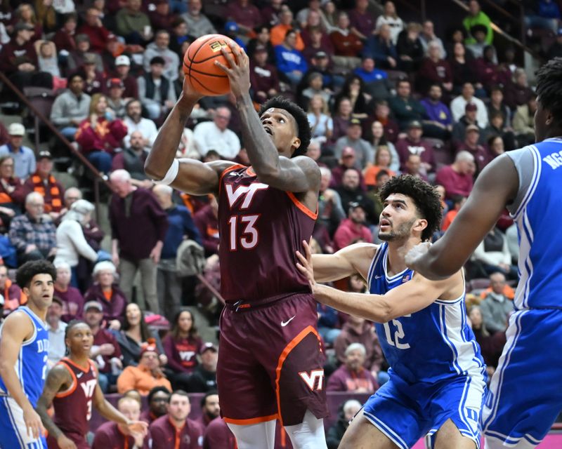 Jan 31, 2026; Blacksburg, Virginia, USA;  Virginia Tech Hokies forward Amani Hansberry (13) looks to shoot defended by Duke Blue Devils forward Cameron Boozer (12)during the second half at Cassell Coliseum. Mandatory Credit: Brian Bishop-Imagn Images