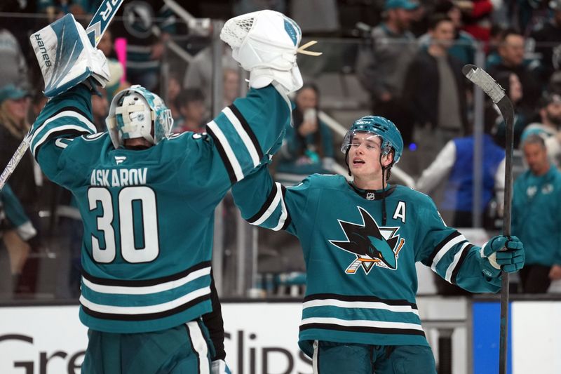 Nov 8, 2025; San Jose, California, USA; San Jose Sharks goaltender Yaroslav Askarov (30) and center Macklin Celebrini (right) celebrate after defeating the Florida Panthers at SAP Center at San Jose. Mandatory Credit: Darren Yamashita-Imagn Images