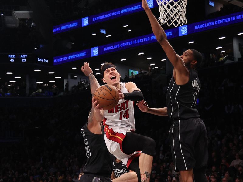 NEW YORK, NEW YORK - JANUARY 15:  Tyler Herro #14 of the Miami Heat shoots against Mikal Bridges #1 of the Brooklyn Nets during their game at Barclays Center on January 15, 2024 in New York City.   User expressly acknowledges and agrees that, by downloading and or using this photograph, User is consenting to the terms and conditions of the Getty Images License Agreement.  (Photo by Al Bello/Getty Images)