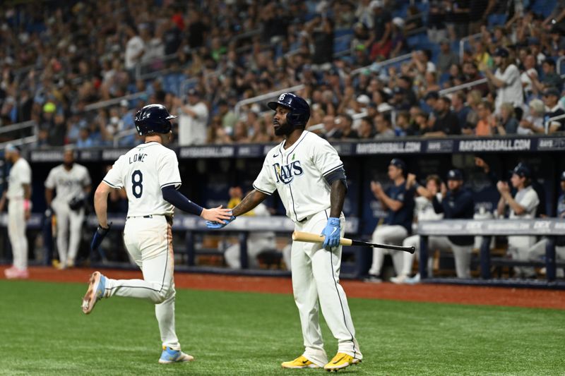 May 29, 2024; St. Petersburg, Florida, USA; Tampa Bay Rays second baseman Brandon Lowe (8) is greeted by left fielder Randy Arozarena (56) after scoring a run in the sixth inning against the Oakland Athletics at Tropicana Field. Mandatory Credit: Jonathan Dyer-USA TODAY Sports