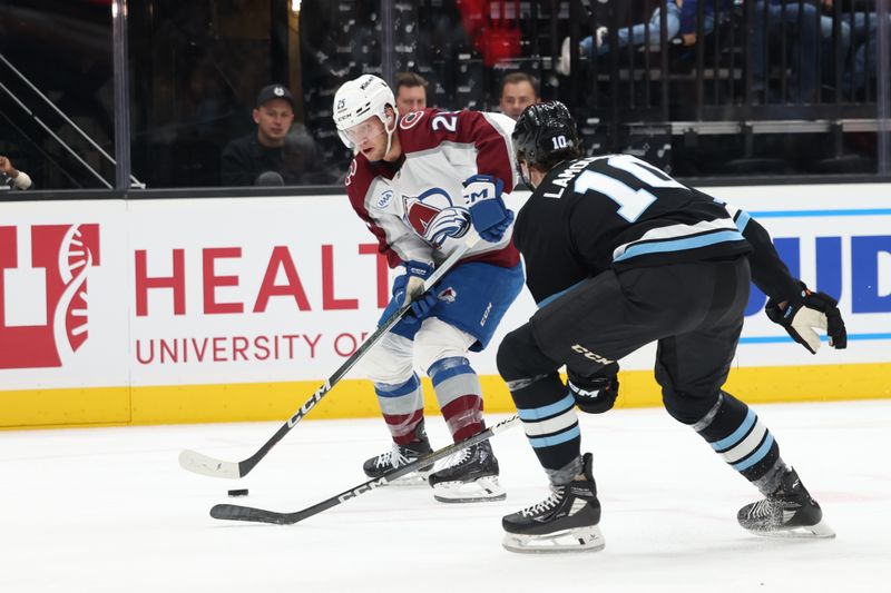 Oct 24, 2024; Salt Lake City, Utah, USA; Colorado Avalanche right wing Logan O'Connor (25) skates with the puck against against Utah Hockey Club defenseman Maveric Lamoureux (10) during the first period at Delta Center. Mandatory Credit: Rob Gray-Imagn Images