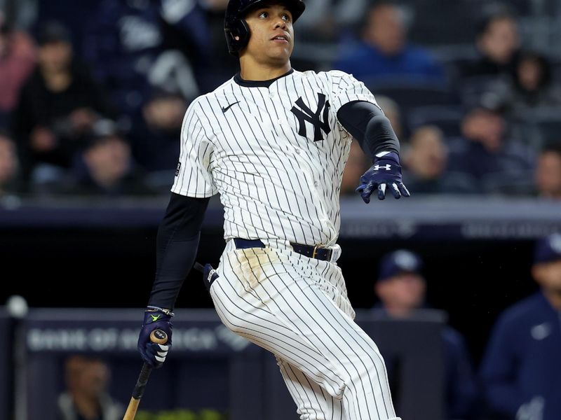 Apr 19, 2024; Bronx, New York, USA; New York Yankees right fielder Juan Soto (22) follows through on a three run home run against the Tampa Bay Rays during the seventh inning at Yankee Stadium. Mandatory Credit: Brad Penner-USA TODAY Sports