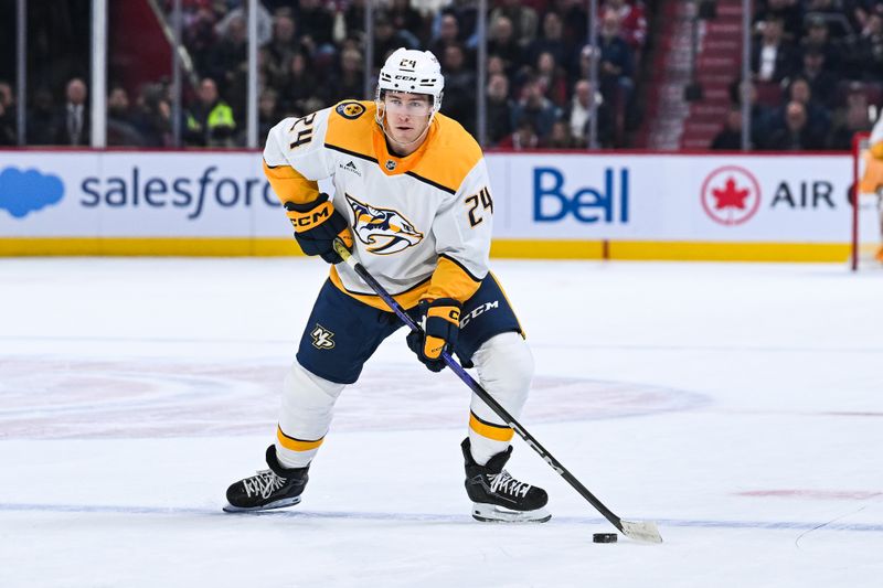 Oct 16, 2025; Montreal, Quebec, CAN; Nashville Predators defenseman Spencer Stastney (24) plays the puck against the Montreal Canadiens during the first period at Bell Centre. Mandatory Credit: David Kirouac-Imagn Images