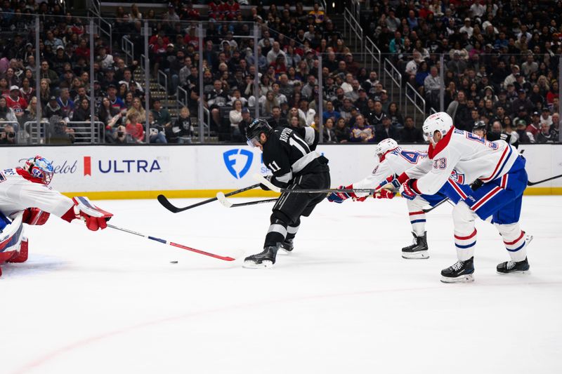 Mar 7, 2026; Los Angeles, California, USA; Los Angeles Kings center Anze Kopitar (11) looks to shoot the puck while under pressure from Montréal Canadiens defensemen Lane Hutson (48) and Noah Dobson (53) during the second period at Crypto.com Arena. Mandatory Credit: William Liang-Imagn Images