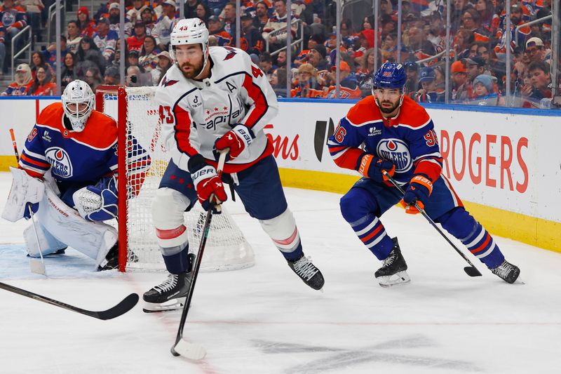 Jan 24, 2026; Edmonton, Alberta, CAN; Washington Capitals forward Tom Wilson (43) looks to make a pass in front of Edmonton Oilers defensemen Jake Wahlman (96) during the second period at Rogers Place. Mandatory Credit: Perry Nelson-Imagn Images