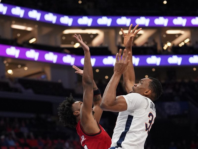 Mar 12, 2026; Charlotte, NC, USA;  irginia Cavaliers center Ugonna Onyenso (33) shoots the ball over NC State Wolfpack guard Jr. Paul McNeil (2) during the first half at Spectrum Center. Mandatory Credit: Jim Dedmon-Imagn Images