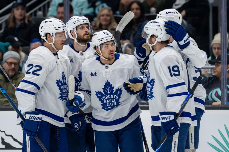 Jan 29, 2026; Seattle, Washington, USA; Toronto Maple Leafs, from left, defenseman Jake McCabe (22), defenseman Oliver Ekman-Larsson (95), forward Nicholas Robertson (89), forward Calle Jarnkrok (19) and forward Nicolas Roy (55) celebrate a goal during the first period at Climate Pledge Arena. Mandatory Credit: Stephen Brashear-Imagn Images