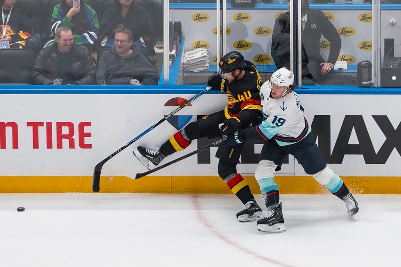 Mar 14, 2026; Vancouver, British Columbia, CAN; Seattle Kraken forward Jared McCann (19) checks Vancouver Canucks forward Elias Pettersson (40) in the first period at Rogers Arena. Mandatory Credit: Bob Frid-Imagn Images