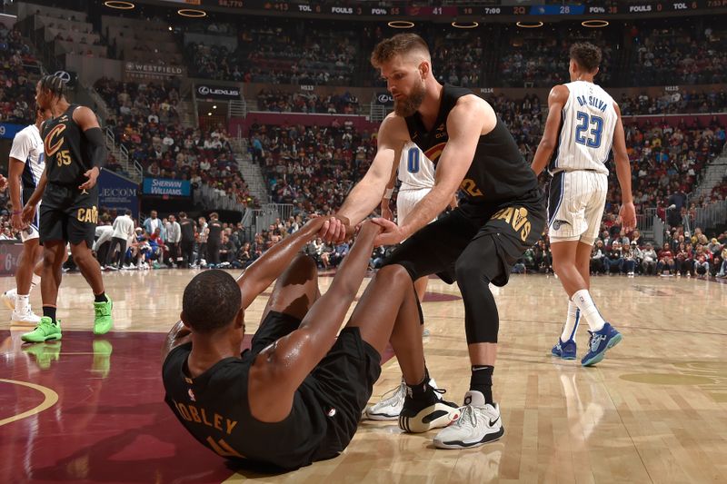 CLEVELAND, OH - NOVEMBER 1: Dean Wade #32 of the Cleveland Cavaliers helps up Evan Mobley #4 during the game against the Orlando Magic on November 1, 2024 at Rocket Mortgage FieldHouse in Cleveland, Ohio. NOTE TO USER: User expressly acknowledges and agrees that, by downloading and/or using this Photograph, user is consenting to the terms and conditions of the Getty Images License Agreement. Mandatory Copyright Notice: Copyright 2024 NBAE (Photo by David Liam Kyle/NBAE via Getty Images)