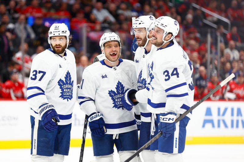 Mar 20, 2024; Washington, District of Columbia, USA; Toronto Maple Leafs center Max Domi (11) celebrates with teammates after scoring a goal against the Washington Capitals during the second period at Capital One Arena. Mandatory Credit: Amber Searls-USA TODAY Sports