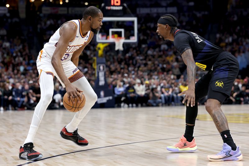 DENVER, COLORADO - MARCH 27: Kevin Durant #35 of the Phoenix Suns is guarded by Kentavious Caldwell-Pope #5 of the Denver Nuggets during the first quarter at Ball Arena on March 27, 2024 in Denver, Colorado. NOTE TO USER: User expressly acknowledges and agrees that, by downloading and or using this photograph, User is consenting to the terms and conditions of the Getty Images License Agreement.  (Photo by Matthew Stockman/Getty Images)