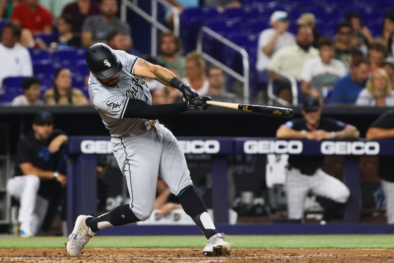 Jul 5, 2024; Miami, Florida, USA; Chicago White Sox right fielder Tommy Pham (28) hits a single against the Miami Marlins during the fourth inning at loanDepot Park. Mandatory Credit: Sam Navarro-USA TODAY Sports