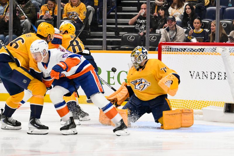 Jan 8, 2026; Nashville, Tennessee, USA; Nashville Predators goaltender Juuse Saros (74) blocks the shot of from New York Islanders left wing Emil Heineman (51) during the second period at Bridgestone Arena. Mandatory Credit: Steve Roberts-Imagn Images