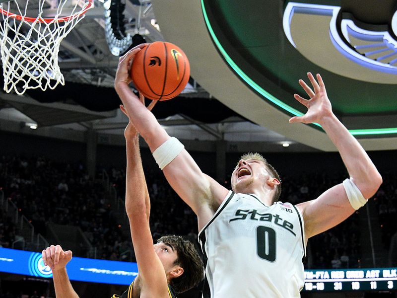 Dec 2, 2025; East Lansing, Michigan, USA;  Michigan State Spartans forward Jaxon Kohler (0) controls a second half rebound against the Iowa Hawkeyes at Jack Breslin Student Events Center. Mandatory Credit: Dale Young-Imagn Images