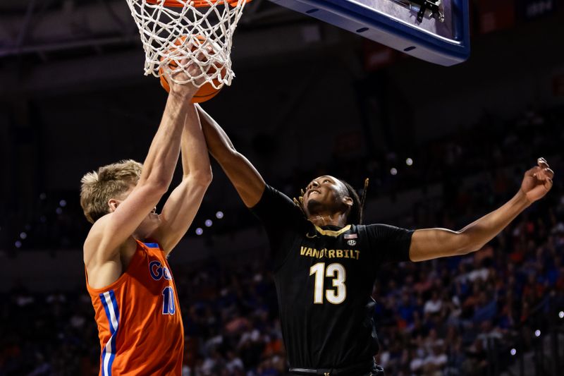 Feb 24, 2024; Gainesville, Florida, USA; Vanderbilt Commodores guard Malik Presley (13) attempts to steal a rebound from Florida Gators forward Thomas Haugh (10) during the first half at Exactech Arena at the Stephen C. O'Connell Center. Mandatory Credit: Matt Pendleton-USA TODAY Sports