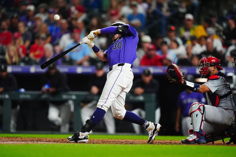 Sep 24, 2024; Denver, Colorado, USA; Colorado Rockies third base Aaron Schunk (30) hits a infield RBI single in the fifth inning against the St. Louis Cardinals at Coors Field. Mandatory Credit: Ron Chenoy-Imagn Images