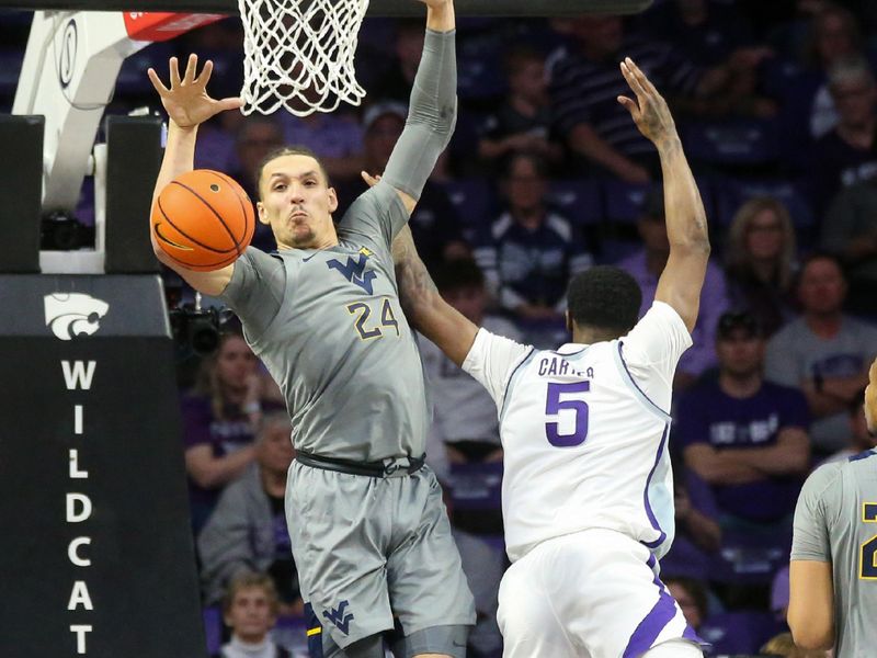 Feb 26, 2024; Manhattan, Kansas, USA; Kansas State Wildcats guard Cam Carter (5) has his shot blocked by West Virginia Mountaineers forward Patrick Suemnick (24) during overtime at Bramlage Coliseum. Mandatory Credit: Scott Sewell-USA TODAY Sports