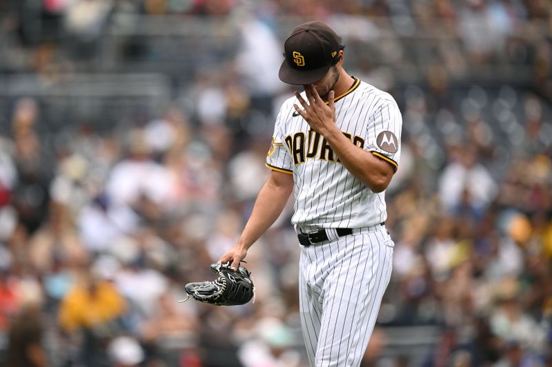 May 17, 2023; San Diego, California, USA; San Diego Padres starting pitcher Yu Darvish (11) wipes his face while walking to the dugout during the fourth inning against the Kansas City Royals at Petco Park. Mandatory Credit: Orlando Ramirez-USA TODAY Sports