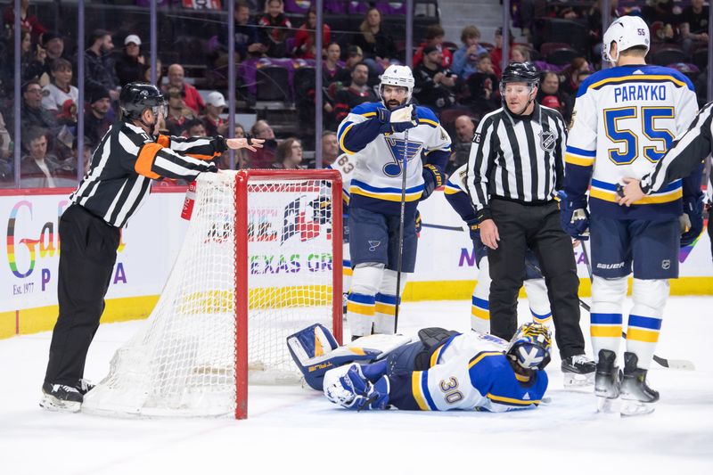 Mar 21, 2024; Ottawa, Ontario, CAN; St. Louis Blues goalie Joel Hofer (30) stays down after making a save in the first period against the Ottawa Senators at the Canadian Tire Centre. Mandatory Credit: Marc DesRosiers-USA TODAY Sports