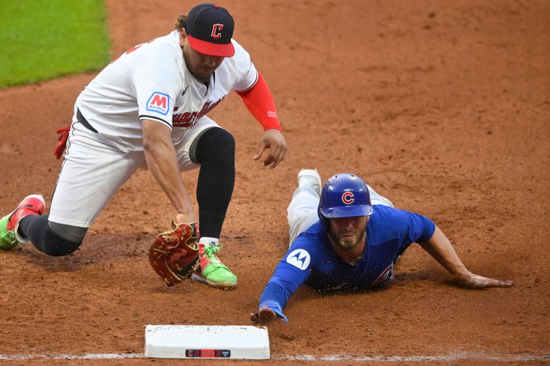 Aug 14, 2024; Cleveland, Ohio, USA; Chicago Cubs first baseman Michael Busch (29) dives safely to first base beside Cleveland Guardians first baseman Josh Naylor (22) on a pickoff attempt in the sixth inning at Progressive Field. Mandatory Credit: David Richard-USA TODAY Sports