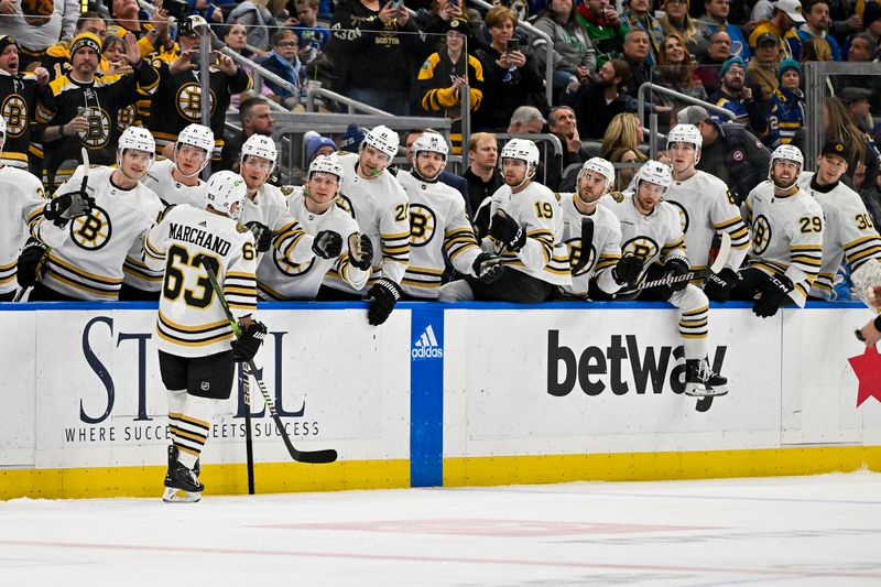 Jan 13, 2024; St. Louis, Missouri, USA;  Boston Bruins left wing Brad Marchand (63) is congratulated by teammates after scoring against the St. Louis Blues during the first period at Enterprise Center. Mandatory Credit: Jeff Curry-USA TODAY Sports