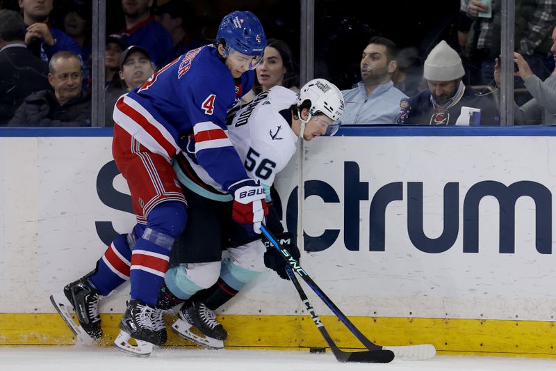 Jan 16, 2024; New York, New York, USA; New York Rangers defenseman Braden Schneider (4) fights for the puck against Seattle Kraken right wing Kailer Yamamoto (56) during the second period at Madison Square Garden. Mandatory Credit: Brad Penner-USA TODAY Sports