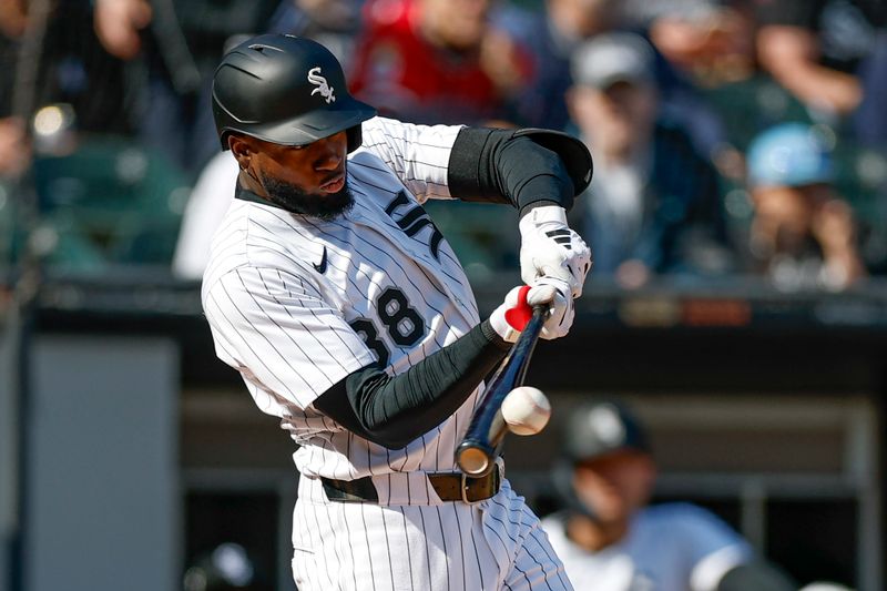 May 24, 2025; Chicago, Illinois, USA; Chicago White Sox center fielder Luis Robert Jr. (88) doubles against the Texas Rangers during the fourth inning at Rate Field. Mandatory Credit: Kamil Krzaczynski-Imagn Images