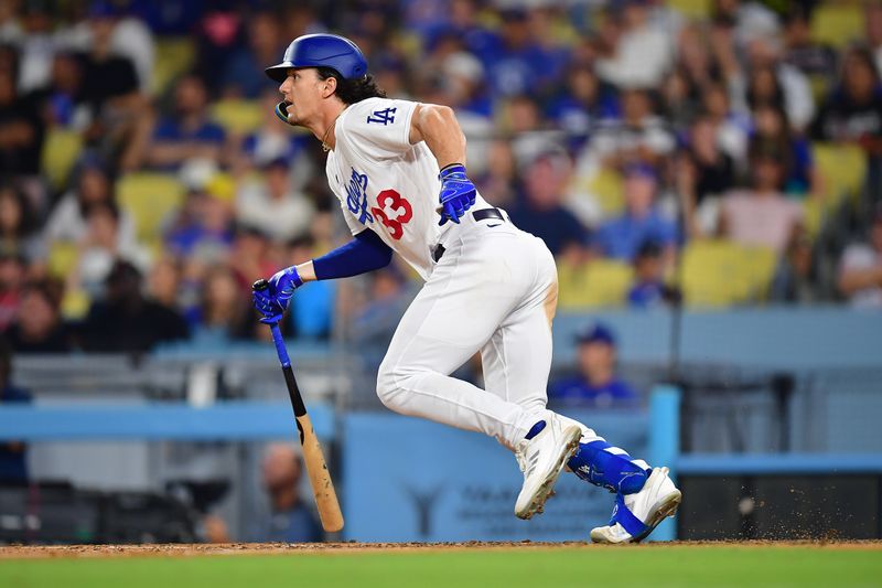 September 1, 2023; Los Angeles, California, USA; Los Angeles Dodgers center fielder James Outman (33) runs after hitting a single against the Atlanta Braves during the eighth inning at Dodger Stadium. Mandatory Credit: Gary A. Vasquez-USA TODAY Sports