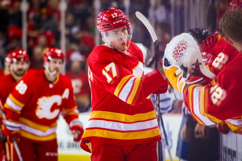 Jan 18, 2024; Calgary, Alberta, CAN; Calgary Flames center Yegor Sharangovich (17) celebrates his goal with teammates against the Toronto Maple Leafs during the first period at Scotiabank Saddledome. Mandatory Credit: Sergei Belski-USA TODAY Sports