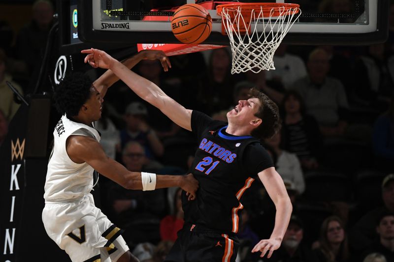 Mar 9, 2024; Nashville, Tennessee, USA; Vanderbilt Commodores guard Tyrin Lawrence (0) has his shot blocked by Florida Gators forward Alex Condon (21) during the second half at Memorial Gymnasium. Mandatory Credit: Christopher Hanewinckel-USA TODAY Sports